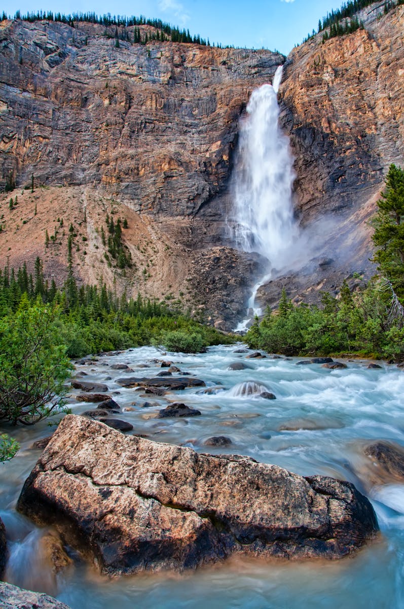 Stunning waterfall cascading down cliffs in Yoho National Park, Canada